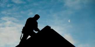 Contractors Invited to Bid on the La Guerite Roof Repairs Project Contractor in Silhouette working on a Roof Top